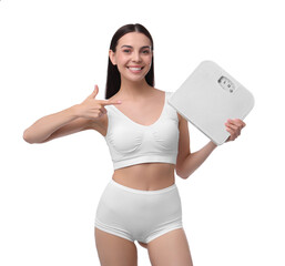 Canvas Print - Diet and weight loss concept. Happy young woman with floor scale on white background