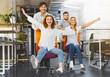 © Prostock-studio - Time for break. Happy colleagues having fun at workplace, making office chair race in coworking space