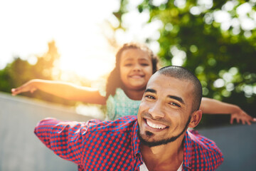 Sticker - Dad, girl and portrait in home on piggyback with playing for fun, bonding and child development. Parent, kid and happy man for support, trust and care together for break, relax and love outdoor