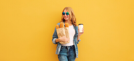 Happy bakery buyer young woman holding grocery shopping paper bag with bread baguette drinks coffee