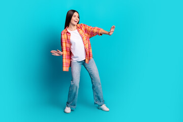 Poster - Full body portrait of nice girl dancing empty space wear checkered shirt isolated on turquoise color background