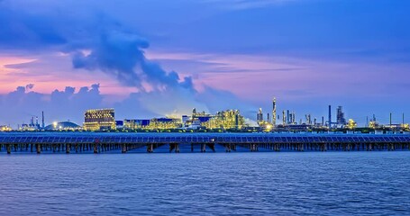 Canvas Print - Time-lapse of industrial buildings and solar panels with river at sunset