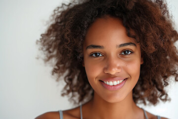 Wall Mural - Pretty young dark skin woman smiling isolated on white background. Generative AI.