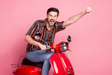 Wall Mural - Profile portrait of nice young man drive bike wear shirt isolated on pink color background