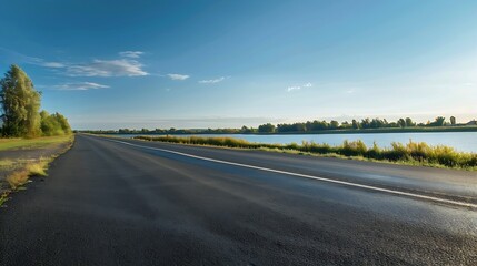 Wall Mural - Empty asphalt road near the lake under blue sky : Generative AI