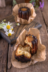 Wall Mural - Portion of canele dessert on wooden background