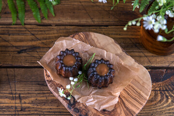 Wall Mural - Portion of canele dessert on wooden background