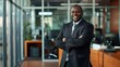© The Little Hut - Accountant portrait and corporate black man in office with confidence pride and smile in workspace Mature employee in professional accounting company with arms crossed and optimistic m : Generative AI