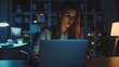 © The Little Hut - Keeping her mind on the deadline a young businesswoman working on a laptop in an office at night : Generative AI