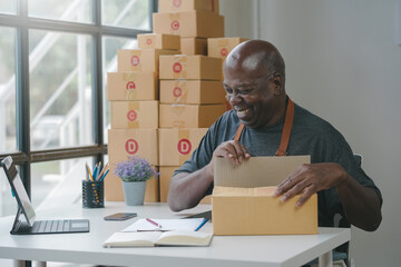 man working on online store, packing box. online business, small business owner managing inventory. 