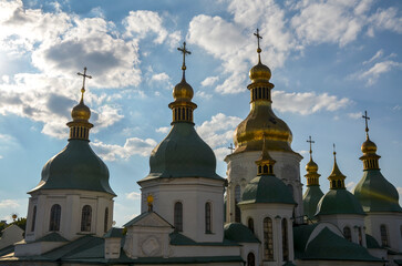 Wall Mural - Saint Sophia Cathedral adorned with multiple onion green and gold color domes, each crowned with a delicate cross. Unique monument of architecture and monumental art of the early 11th century. Kyiv