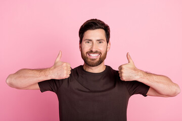 Wall Mural - Portrait of toothy beaming man with bristle stylish hairdo wear brown shirt two arms showing thumbs up isolated on pink color background