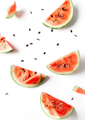 Wall Mural - Slices of fresh juicy watermelon falling on white background