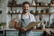 © Maxim Borbut - The handsome plumber in the kitchen holds a clipboard and stares at the camera