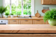 © organik - Wooden table on blurred kitchen bench background. Empty wooden table and blurred kitchen background for product mockup