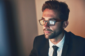 Man, eyewear and reflection of computer at night in office, cybersecurity and nerd for pc system. Male person, software development and planning on website in dark, programmer and online for project