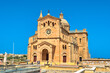 © Scotts Travel Photos - Ta Pinu, Malta - June 25, 2024: The Basilica of the National Shrine of the Blessed Virgin of Ta Pinu on a sunny day. Roman Catholic minor basilica is a Catholic religious building.