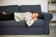 © Anatoliy Karlyuk - Tired lazy exhausted caucasian female sleeping on sofa lying on belly with hands under head, being couch potato on weekend, sitting at home, relaxing, having rest after stressful work week