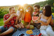 © maxbelchenko - Young cheerful friends happy positive smile eat fruit watermelon party countryside outdoors. Foods, travel, nature and picnic concept