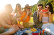 © maxbelchenko - Young cheerful friends happy positive smile eat fruit watermelon party countryside outdoors. Foods, travel, nature and picnic concept