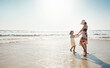 © Reese Coop/peopleimages.com - Mom, girl and vacation with dancing at beach, waves and holding hands with child by mockup space in summer. Holiday, mother and daughter with connection, bonding and love by sea with care in Croatia