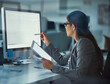 © Seisa/peopleimages.com - Computer screen, night and web development with woman at desk in office for coding or programming. Information, software and tech with business person in workplace for project management on tablet