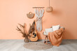© Pixel-Shot - Interior of stylish living room with wall tapestry, armchair and guitar