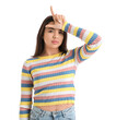© Pixel-Shot - Young woman showing loser gesture on white background