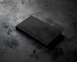 © wahyu - Black rectangle on textured black surface, mockup template for design presentation.  Blank space for product display