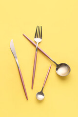 Wall Mural - Stylish cutlery on yellow background