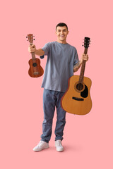 Poster - Handsome young man with guitars on pink background