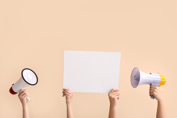 Sticker - Female hands with megaphones and blank poster on beige background