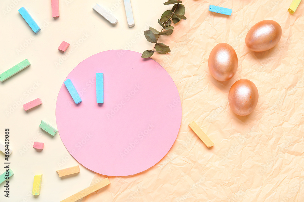 Easter eggs, chalks, dried flowers and empty card on paper background