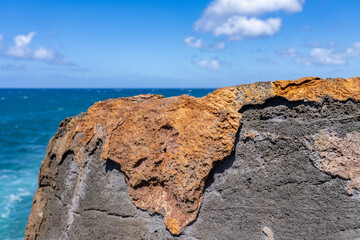 Wall Mural - Waves hitting the Lava rock， Makahuena Light, Koloa, Kauai South Shore，Hawaii. Koloa Volcanics	，basalt