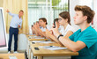 © JackF - Pupils with smartphones sitting in class and photographing something on chalk board.