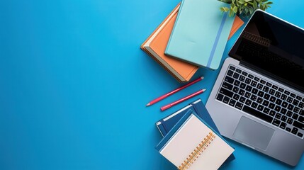 Leinwandbilder - A laptop, textbooks, and pencils lay on a blue desk, showcasing contemporary learning methods. Generative AI