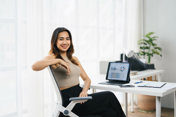 Confident Asian Business Woman Working in Modern Office with Laptop and Documents