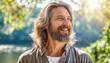 © ROKA Creative - Smiling middle-aged bearded man outdoors with blurred greenery