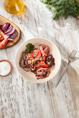 Wall Mural - Top View of a Healthy Roast Beef and Tomato Salad Served on a Wooden Table, Bright Daylight Setting