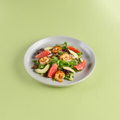 Canvas Print - Fresh Shrimp Salad With Avocado and Grapefruit on a Light Green Background