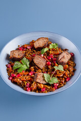 Wall Mural - Title Minimalist Beef and Pomegranate Pilaf Against Blue Background