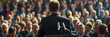 © john - A politician addresses an attentive crowd from a podium