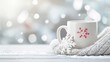 © Volodymyr Skurtul - White Mug with Red Snowflake Design Resting on Yarn Blanket Amidst Blurred Cityscape
