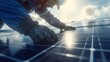 © narak0rn - Close-up of a worker installing solar panels on a roof, promoting renewable energy and sustainable technology under bright sunlight.