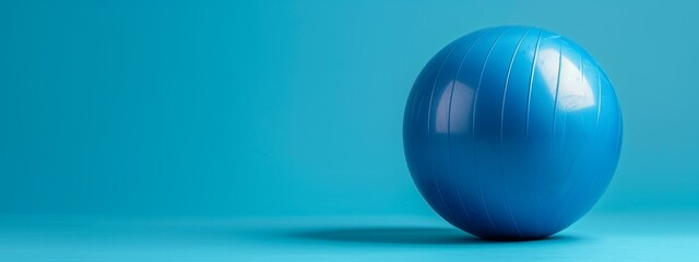 Wall Mural -  A large blue ball sits atop a blue floor, surrounded by light-blue walls in a room's center