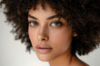 © Kevin - A photograph of a mixed-race woman with Spanish and European heritage, confident pose, straight-on angle, half-body shot. White background.
