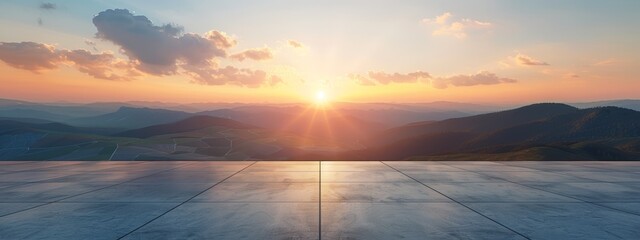  The sun sets over mountain ranges, featuring a tile-floored foreground and mountainous background