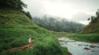 © oatawa - Happy young asian tourist female walking in meadow with mountains and fog at Khao Chong Lom new landmark of Thailand, Carefree woman in fields and stream, Rest on vacation holiday weekend