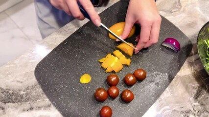 Poster - A person is cutting up a variety of fruits and vegetables on a cutting board
