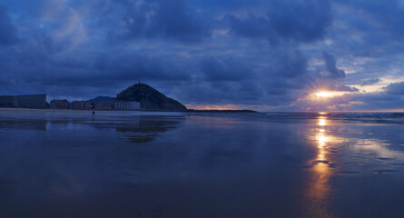 Wall Mural - Sunset on the beach. Sunset on the Zurriola beach, city of Donostia San Sebastian, Basque Country.